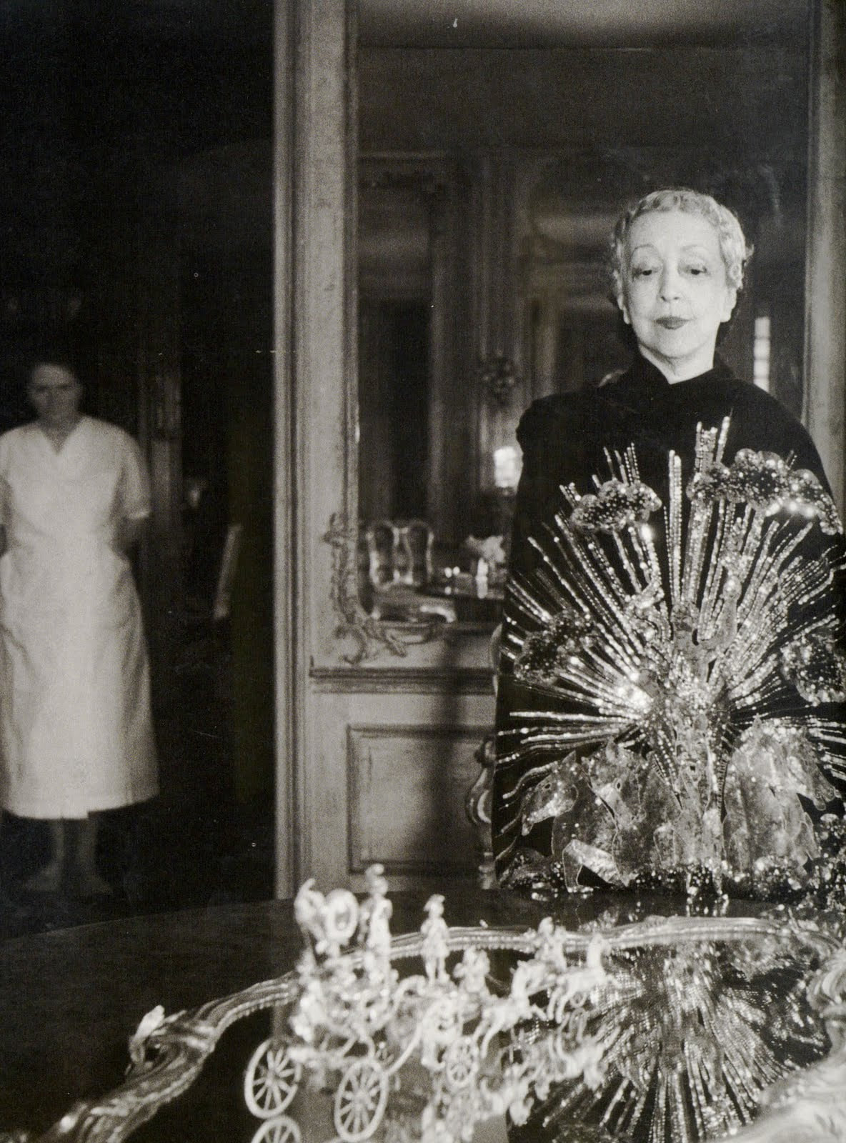 Elsie de Wolfe, Lady Mendl wearing Apollo of Versailles Cape by Elsa Schiaparelli embroidered by Lesage, Zodiac Collection, 1939, by Cecil Beaton